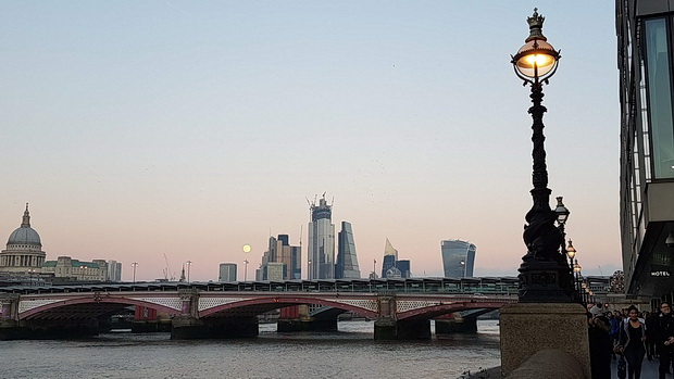 A big Moon over the River Thames - in photos