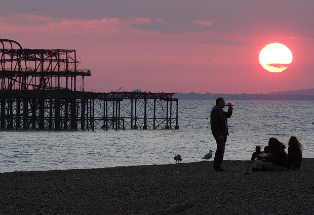 Brighton West Pier sunset - photos of the autumnal sun setting over the doomed Victorian pier, Sussex, England