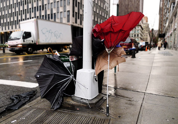 Rain clouds over Brooklyn leave umbrellas buckling, New York