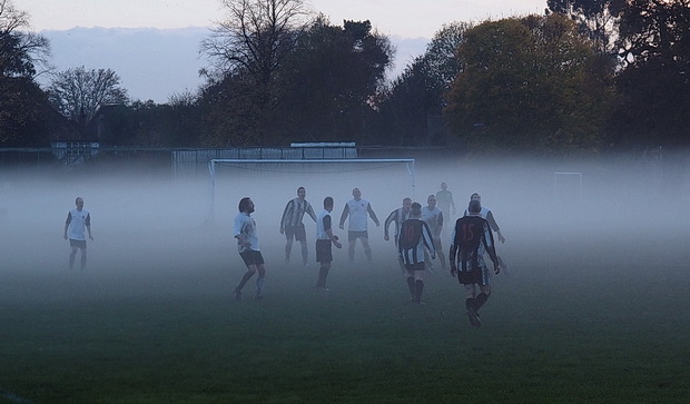 Ghostly football -players hunt the ball in the swirling mists of Molesey, Surrey, Saturday 15th November 2014