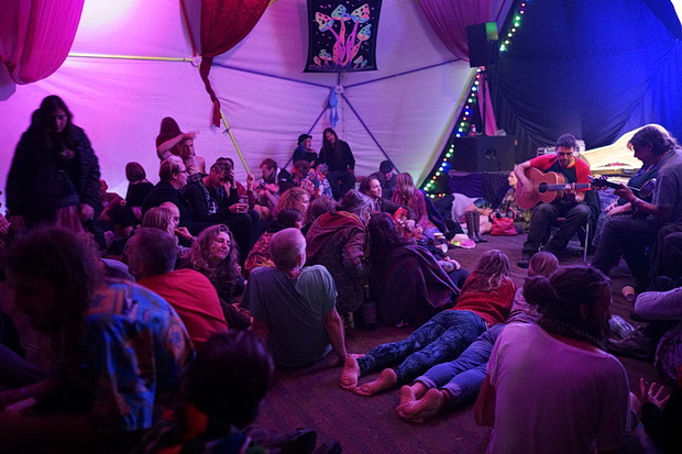 Green Gathering 2016 in photos. Night scenes: camp fires, upside down performers, bands and DJs, Chepstow, Wales, August 2016