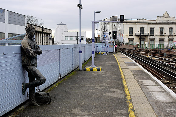 Human statues, Brixton railway station platform