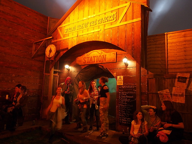 Pistol packin' bucking bronco scenes from Boomtown's Wild West, Boomtown Fair Festival 2015, Winchester, England, UK, August 2015