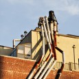 I spotted this crazy collection of spider-like chimneys stuck on the side of a building in New York’s lower Manhattan. [More New York photos]