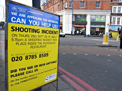 Yellow police incident boards, gun shootings on Coldharbour Lane, Brixton, Lambeth, London SW9, 2006