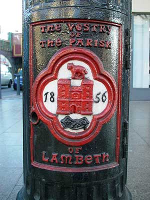 Lamp post at north-east corner of Atlantic Road and Brixton Road showing the vestry mark of the Parish of Lambeth, Brixton, London