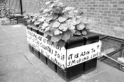 Religious slogans on plant pots outside Brixton Police Station, Gresham Road,  Brixton, Lambeth, London SW9