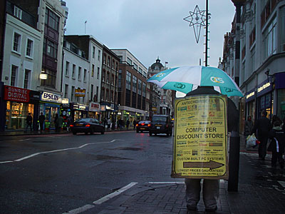 Wet human billboard and umbrella, Tottenham Court Road, London W1