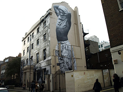 Artwork papered onto Foyles and surrounding buildings, Manette Street, central London