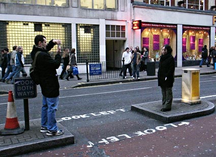 Taking a picture, Charing Cross Road, London