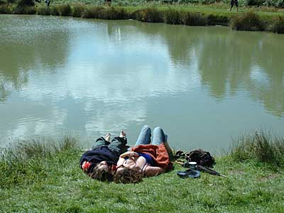 Relaxing by the lake, Big Chill festival, Ledbury, Herefordshire, England UK