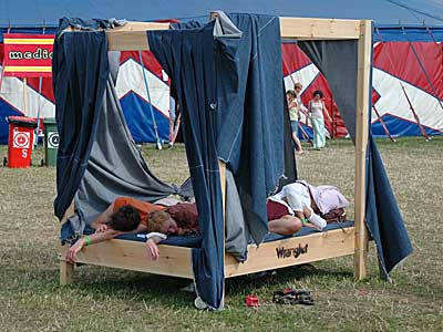 Sleeping it off on a giant bed, Big Chill festival, Eastnor Castle, Ledbury, Herefordshire, England UK