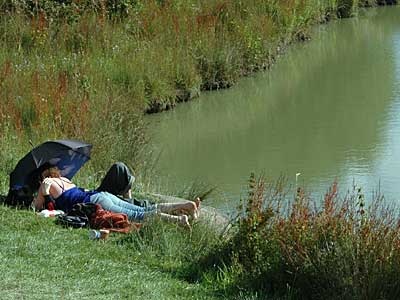 Relaxing by the lake, Big Chill festival, Eastnor Castle, Ledbury, Herefordshire, England UK