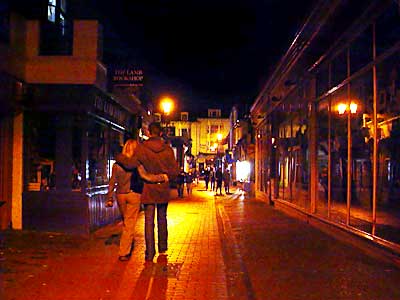 Couple walking arm in arm along Kensington Gardens Brighton at night, October 2003