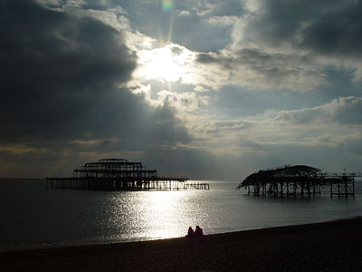 West Pier, beach and walkers, Brighton, East Sussex