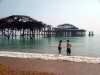 Bathers in front of West Pier damaged by fire Brighton, May 2003