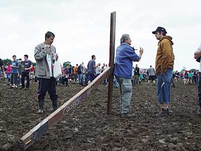 Bloke dragging a cross through the Other Stage, Glastonbury Festival, June 2004