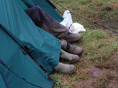 Muddy boots and tent, Glastonbury Festival, Pilton, Somerset, England June 2005