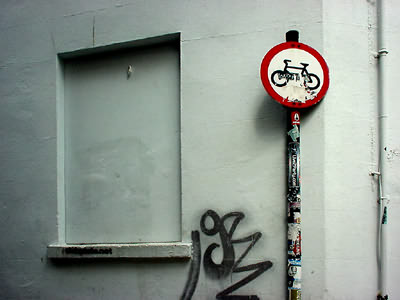 signpost and white wall