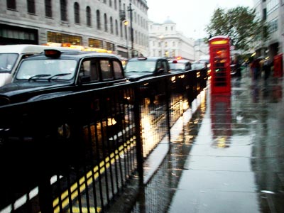 Taxi cabs, telephone boxes and rain, Strand, London