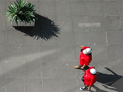 White caps, red shirts, green plant, South Bank, London