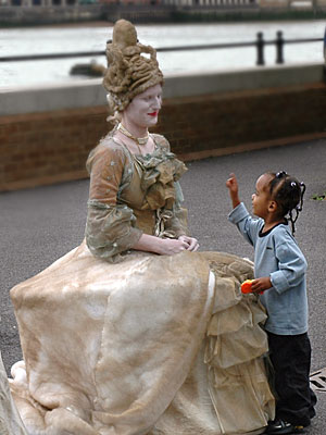 Human statue and little girl, South Bank, London
