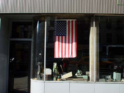 US Flag in store front, Bowery, Manhattan, New York