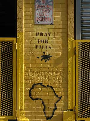 Yellow wall, African map stencil and Pray For Pills, SoHo, New York City, NYC, USA