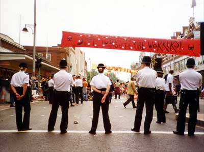 Police and banner, Reclaim the Streets, Brixton High Road, June 1998 