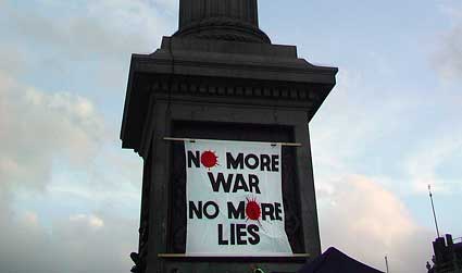 A large banner on Nelson's column, Trafalgar Square reads: 'No More War, No More Lies'.