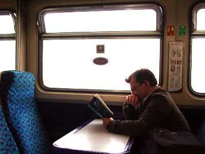 Book reader, St Erth to St Ives branch line train, Cornwall, March 2003