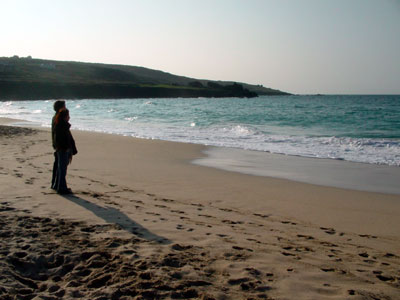 Couple looking out to sea, late afternoon, Porthmeor Beach, St Ives Cornwall, March 2003