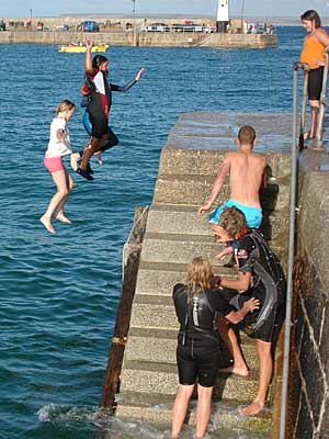 Jumping off the quay side, St Ives harbour, St Ives, Cornwall, August 2005