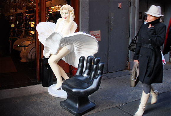 New York sidewalk street scene: Marilyn, a giant hand and a passer by