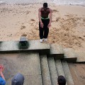 Practising parkour on the sandy beach of the River Thames, South Bank, London