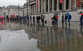 London's shame: long line of hungry homeless people queuing in the rain at Trafalgar Square