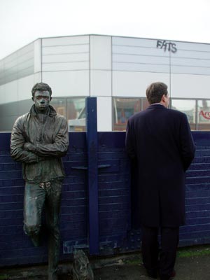 Businessman and statue, Brixton station, Atlantic Road, London SW9