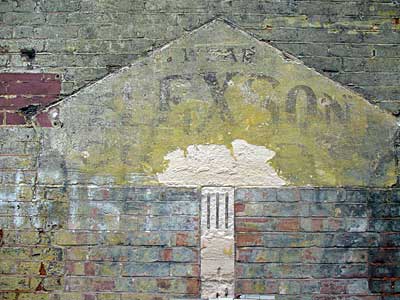 Fast fading advert for Elexson clothing, Electric Mansions, Electric Lane, Brixton Village, Brixton, Lambeth, London, England SW9