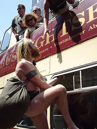 the Naked Protester hands out leaflets to a baffled tourist bus!