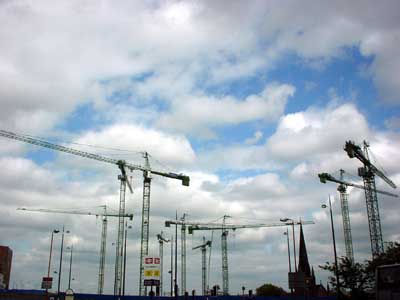 Cranes, spire and streetlamps