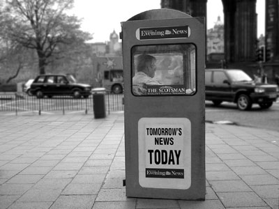 Evening News seller in a box, Princes Street, Edinburgh