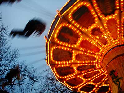 Swinging high, Leicester Square Christmas funfair, December 2003, London