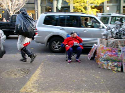 Homeless guy with bag and stall holder, West Broadway, Manhattan, New York