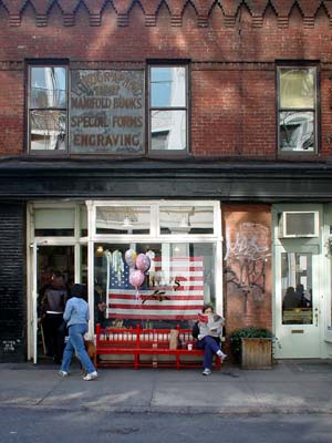 Reading the paper, Prince Street, Manhattan, New York