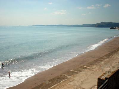 Solitary bather and railings, Dawlish beach, Devon