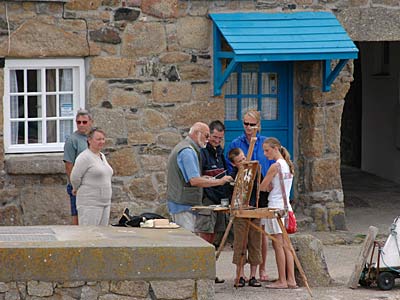 Artist at work, Mousehole harbour, Cornwall, August 2005