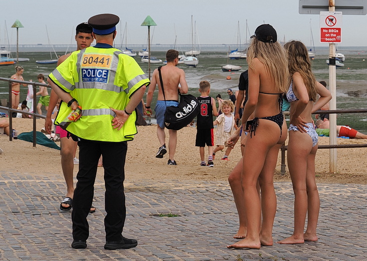 Swimmers and stranded boats on a sea of mud in the shadow of the oil refineries: Leigh on Sea in the summer 